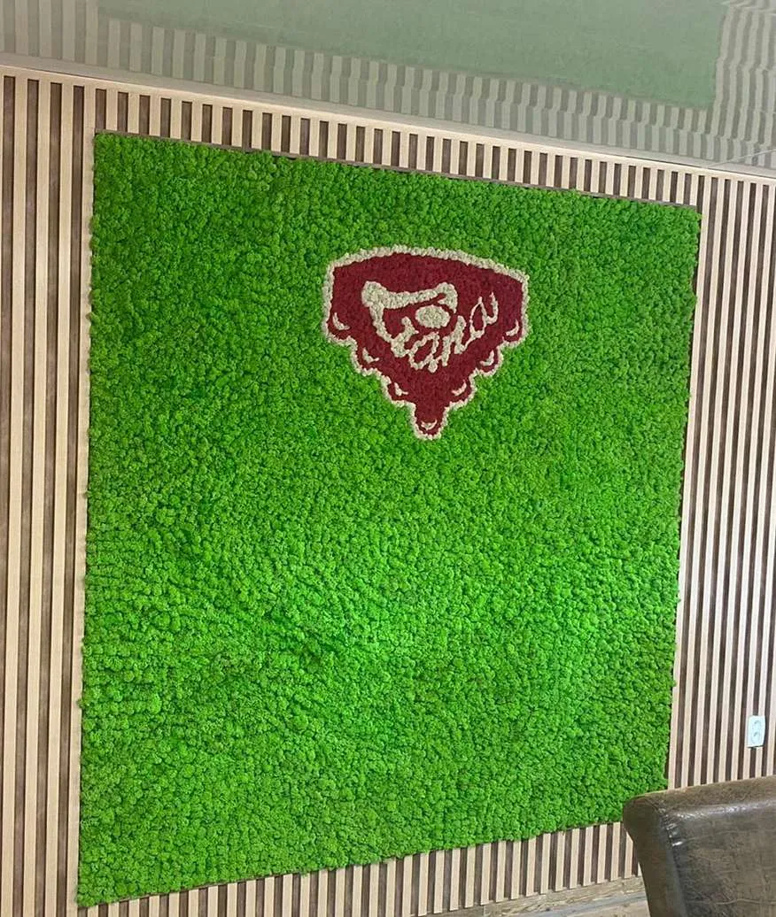 Zielona ściana z mchu z logotypem Liana Słowacja